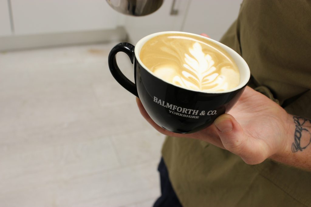 branded coffee cup with latte art for university catering