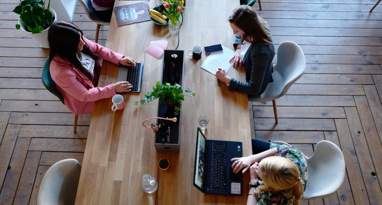 office worker sat around table with coffee