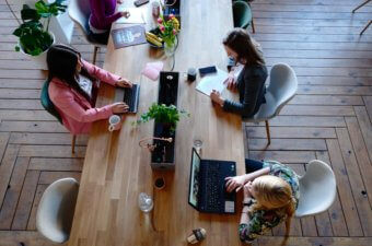 office worker sat around table with coffee