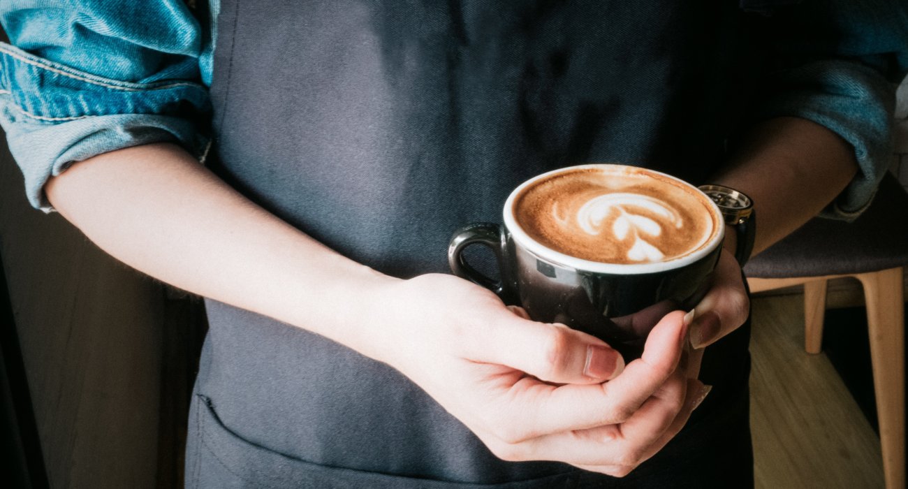 person holding coffee cup