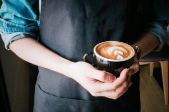 person holding coffee cup