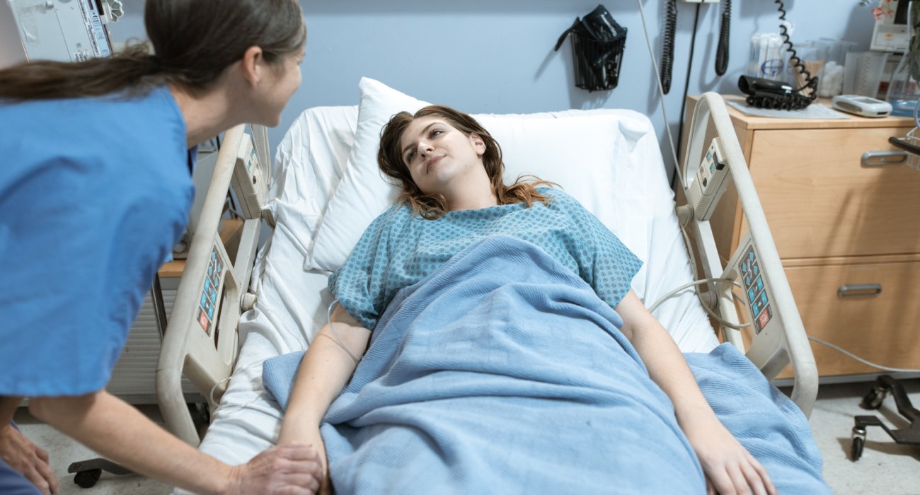 Woman in bed in hospital