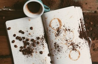 Coffee on top of notebook