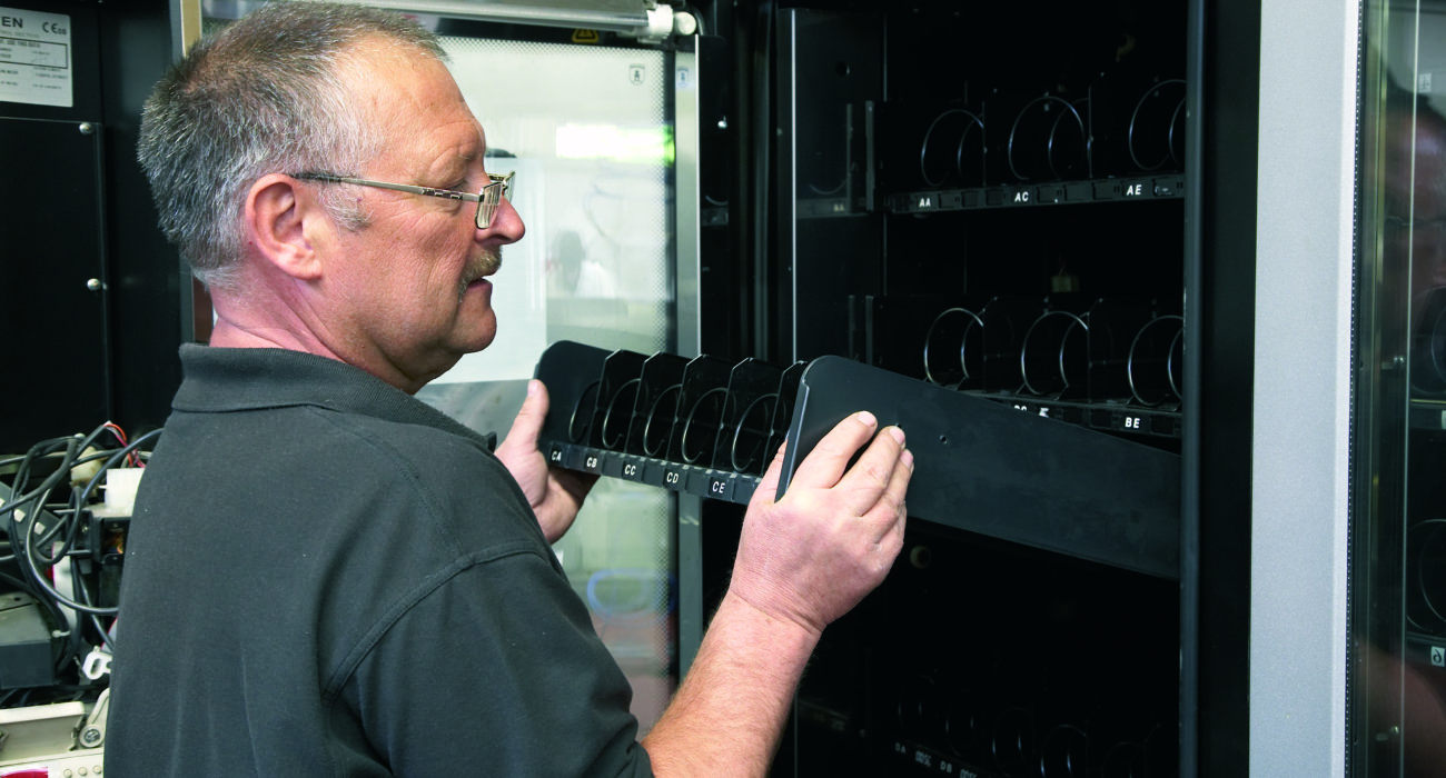 Man fixing vending machine