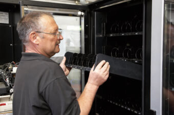 Man fixing vending machine