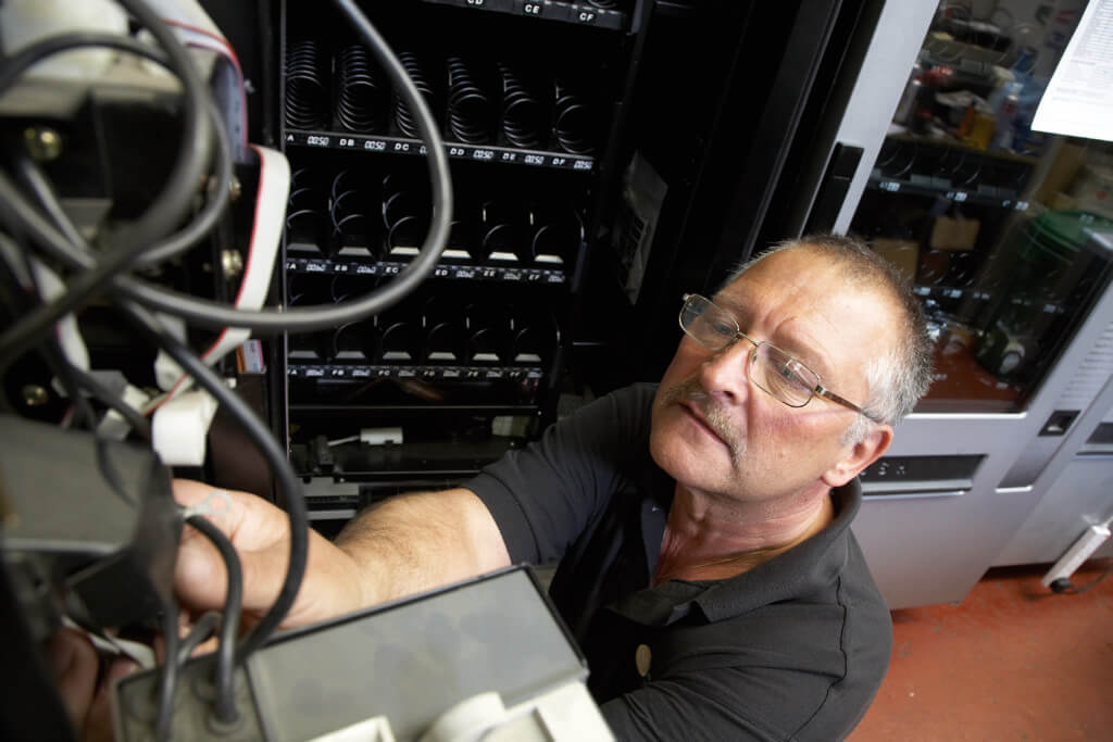 Man fixing vending machine 